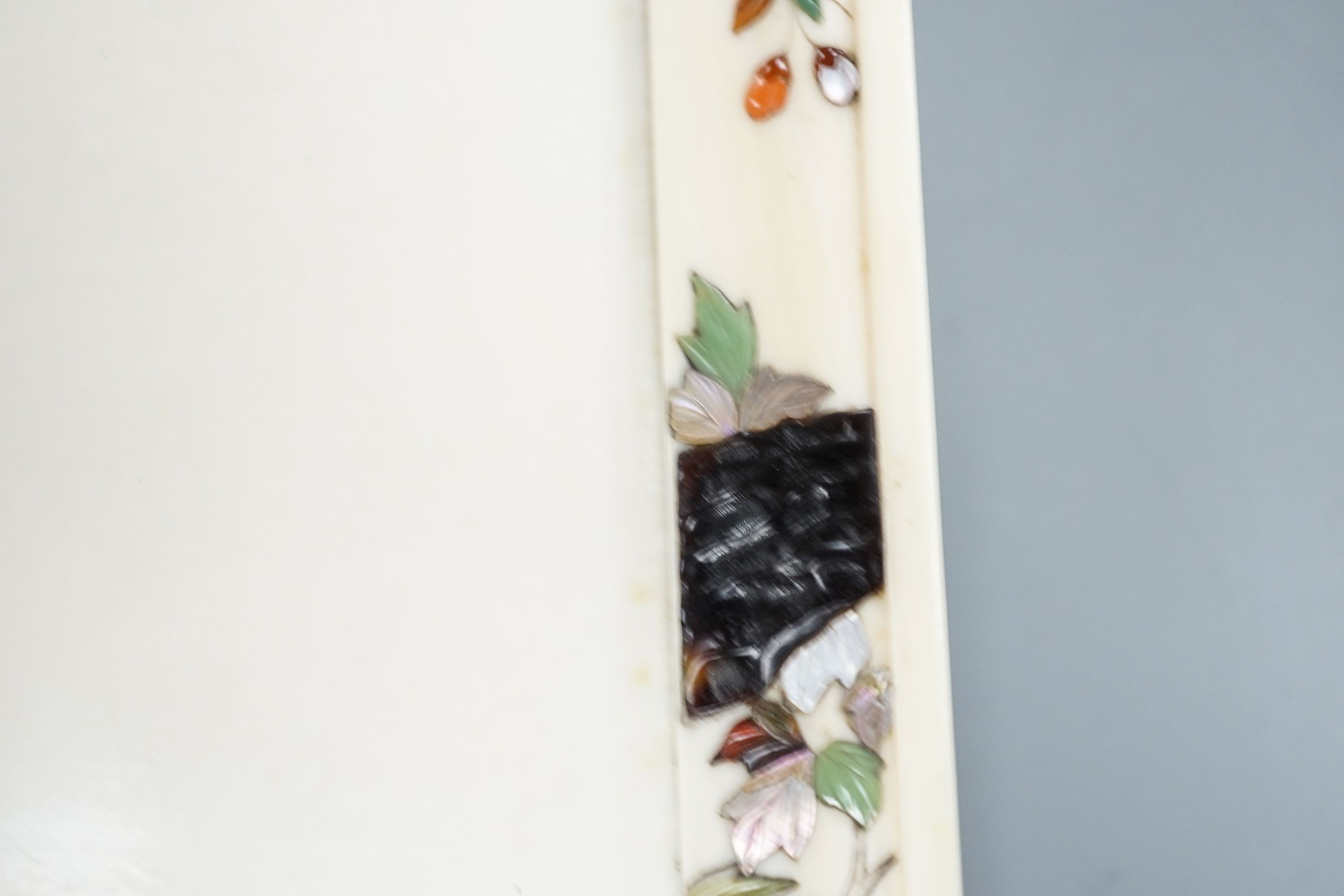 A Japanese ivory tray/plaque, Meiji period, with sunk-in carving of boy with dove, the surround decorated with Shibayama inlaid flowers etc. 15 x 20cm